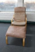 A late 20th century wood framed brown leather armchair and footstool