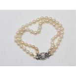 A continental two-strand cultured pearl bracelet on 14ct white gold clasp, length 19cm.
