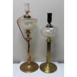 An antique brass paraffin lamp converted to a table lamp and one further similar lamp