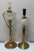 An antique brass paraffin lamp converted to a table lamp and one further similar lamp