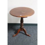 A Victorian mahogany occasional table on three way pedestal