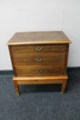 A twentieth century three drawer chest on pine base