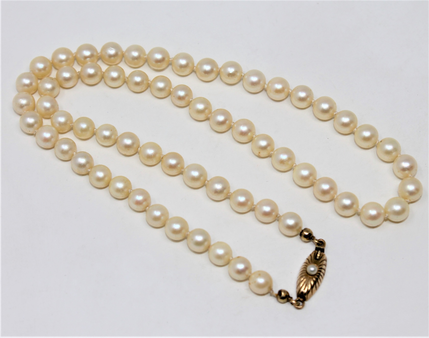A continental cultured pearl necklace on 14ct gold pearl set clasp, length 41cm.