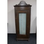 A 20th century glazed sentry door cabinet on bun feet