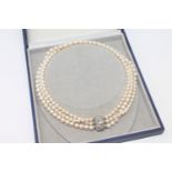 A continental triple-strand cultured pearl necklace on 14ct gold diamond and pearl set clasp,