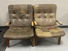 A pair of mid twentieth century leather upholstered armchairs