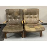 A pair of mid twentieth century leather upholstered armchairs