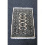 A Bokhara rug on beige ground,