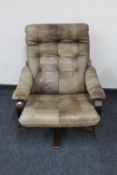 A twentieth century Danish stained beech swivel chair upholstered in leather
