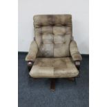 A twentieth century Danish stained beech swivel chair upholstered in leather