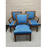 A set of three mahogany armchairs upholstered in blue fabric