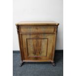 An antique mahogany cabinet fitted with a drawer on paw feet