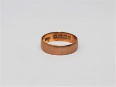 An 18ct gold band ring, size L. CONDITION REPORT: 2.