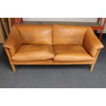 A mid 20th century Danish tan leather two seater settee