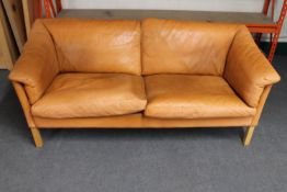 A mid 20th century Danish tan leather two seater settee