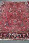 A Heriz rug woollen carpet on red ground,