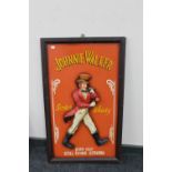 A wooden Johnnie Walker relief panel