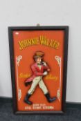 A wooden Johnnie Walker relief panel