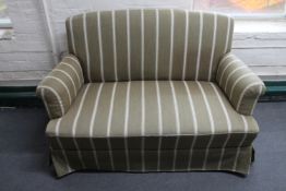 A mid 20th century two seater settee in striped fabric