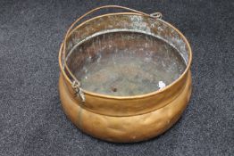 An antique copper swing handled cooking pot