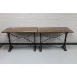 A pair of rectangular bar tables on cast iron legs