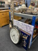 A battery operated wall clock, assorted signs,