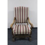 An early twentieth century oak armchair upholstered in striped fabric