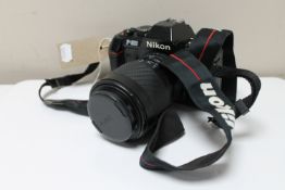 A Nikon F-301 camera with Sigma zoom lens