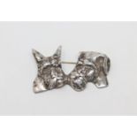 A silver dog brooch modelled as two terriers heads, width 57 mm.