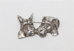 A silver dog brooch modelled as two terriers heads, width 57 mm.