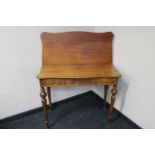 An antique mahogany fold over top tea table