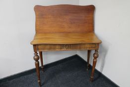 An antique mahogany fold over top tea table