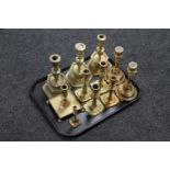 A tray of brass candlesticks