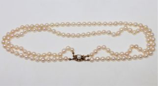 A continental two-stand cultured pearl necklace on 14ct gold pearl set clasp, length 43cm.