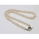 A continental cultured pearl necklace on 14ct gold and blue paste clasp, length 40cm.