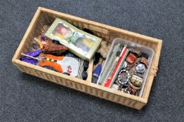 A wicker basket of costume jewellery, wristwatches,