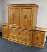An oriental style carved, high gloss breakfront entertainment cabinet fitted cupboards and drawers,