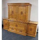 An oriental style carved, high gloss breakfront entertainment cabinet fitted cupboards and drawers,