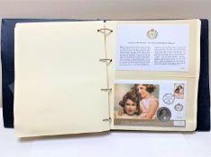 An album containing The Queen's 80th Birthday Coin cover collection, issued number 00552.
