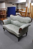 A 19th century mahogany framed shaped backed settee in green classical fabric