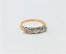 An 18ct gold three stone diamond ring, approximately 0.75 carat, size M.