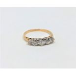 An 18ct gold three stone diamond ring, approximately 0.75 carat, size M.