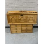 A blond carved oak blanket chest together with an oak six drawer chest