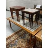 A mid twentieth century Danish tiled coffee table together with a nest of three mahogany tables and