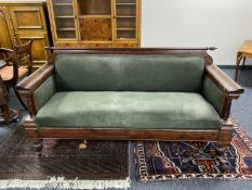 A continental mahogany framed hall settee upholstered in a green fabric