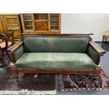 A continental mahogany framed hall settee upholstered in a green fabric