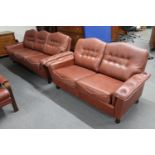 A mid 20th century Danish brown leather three seater settee and matching two seater