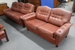 A mid 20th century Danish brown leather three seater settee and matching two seater
