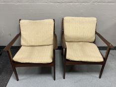 A pair of mid twentieth century teak framed armchairs