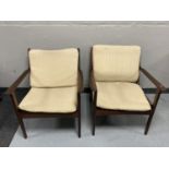 A pair of mid twentieth century teak framed armchairs